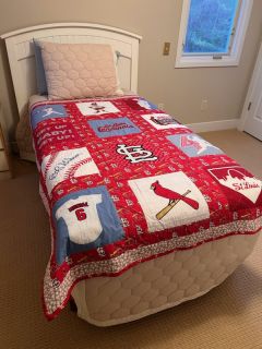 Image of quilt spread out on a twin size bed